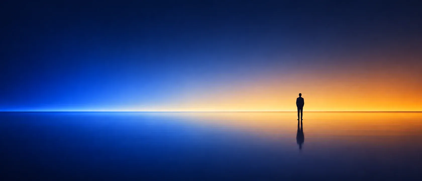 A single figure standing at a horizon where a warm field of light meets a cool one.