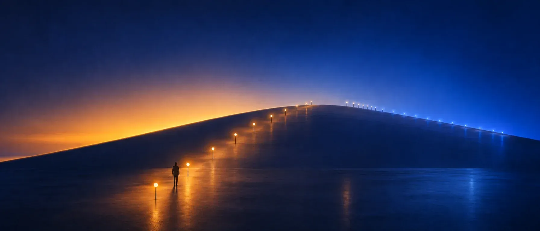 A lone figure at the foot of a gentle rise, where a line of small lights climbs toward the horizon.